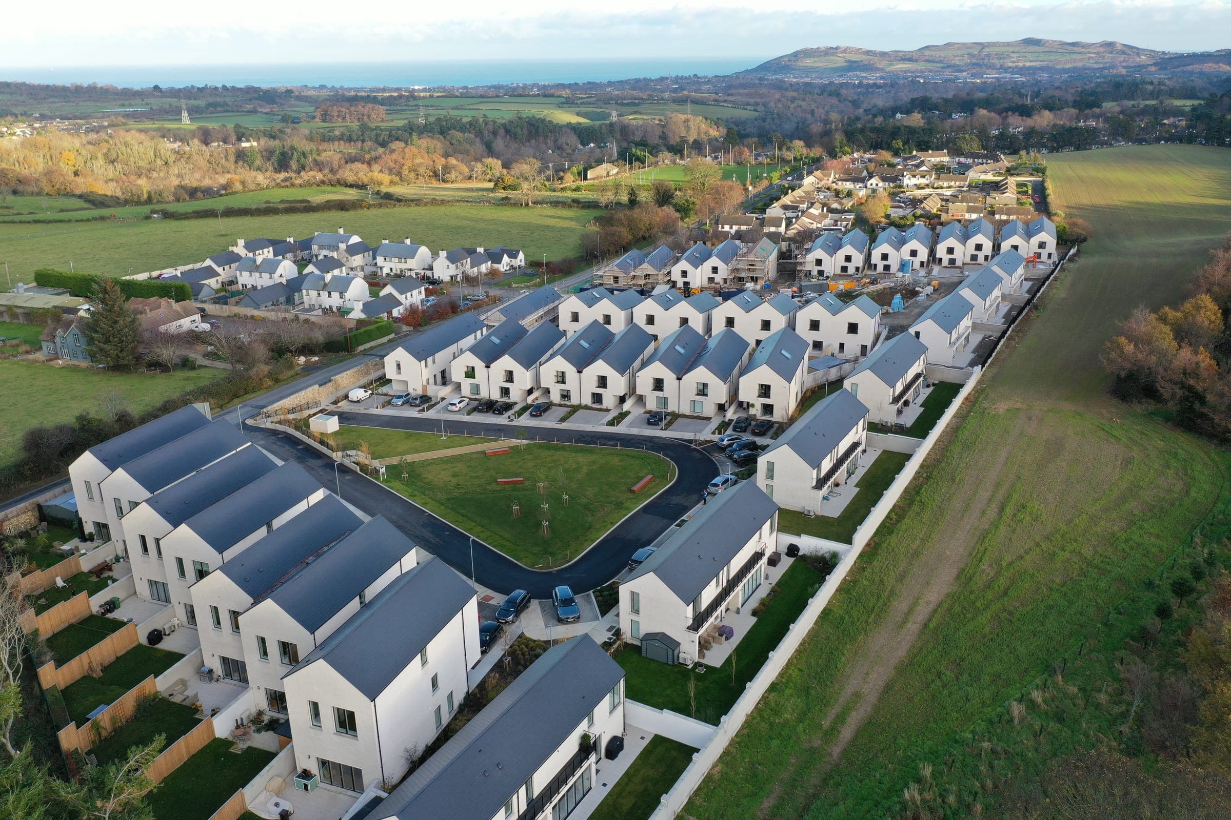 Aerial photograph of Sika Woods, Enniskerry, with the sea beyond